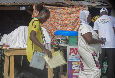NurPhoto via Getty Images Health officials go house to house to immunize children at Agboyi Ori Omi in Agboyi-Ketu, Lagos, Nigeria, on 11 November 2025
