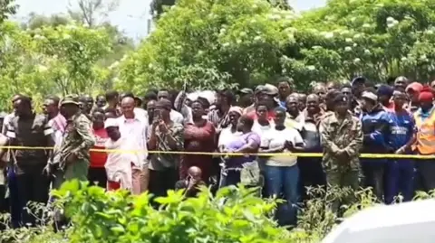 A screengrab from footage shows a crowd that gathered near the burial site as exhumation was going on in Kericho, western Kenya