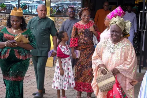 Women, men and children outside a church in Lagos