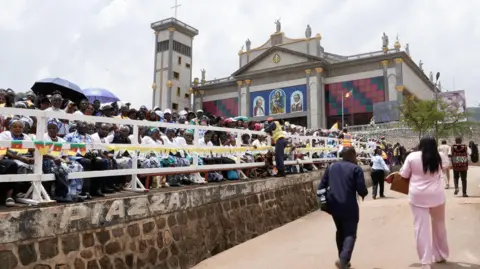 Michel Mvondo / BBC Crowds outside the cathedral in Bamenda gathered for the Pope's peace meeting