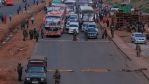 Families lay flowers on barbed wire barricade on anniversary of deadly Kenya protests