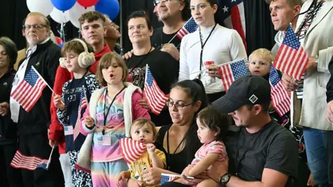 Getty Images The first group of Afrikaners from South Africa to arrive for resettlement  at Washington Dulles International Airport in Virginia, on 12 May,